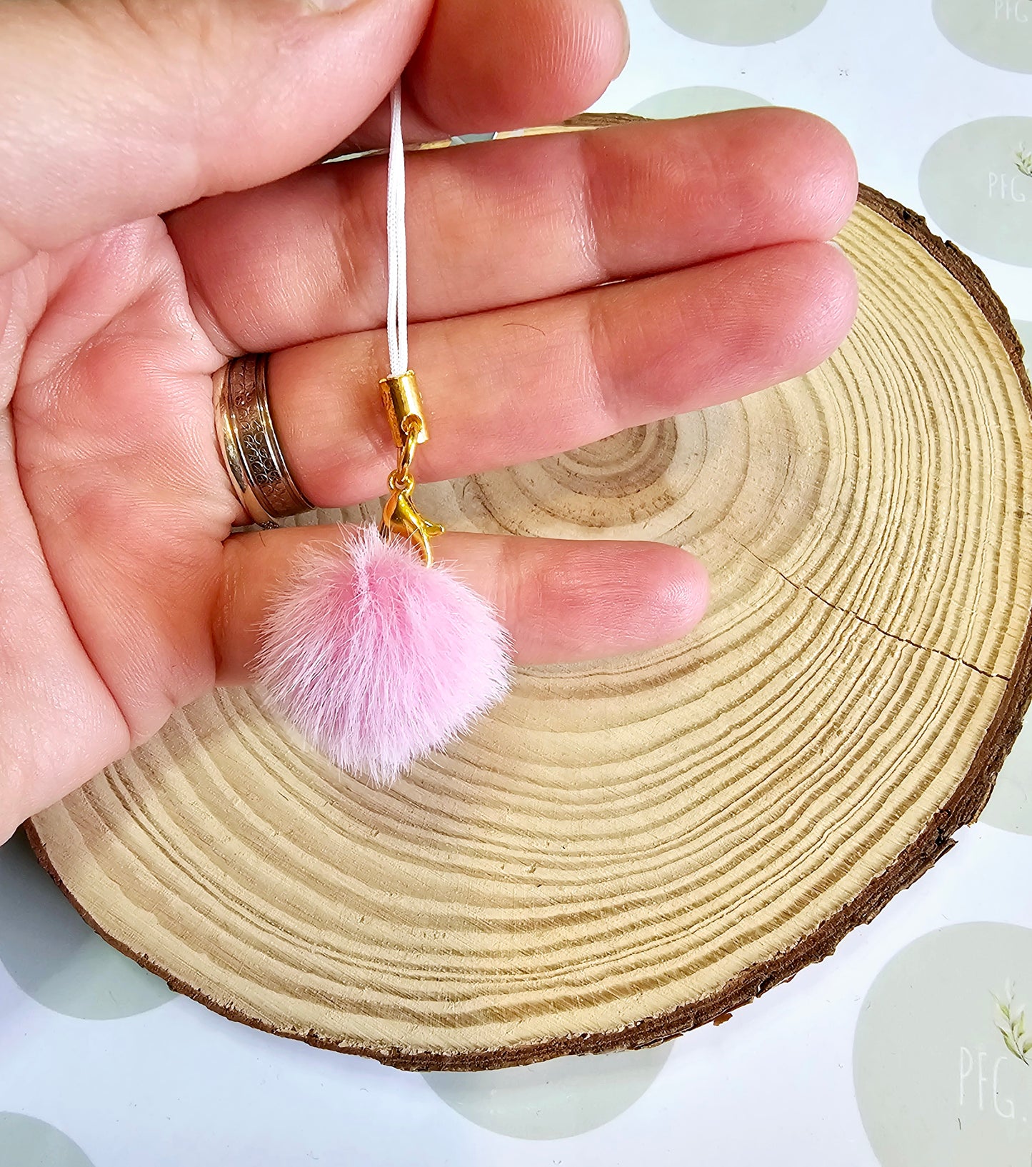Pink pompom phone charm