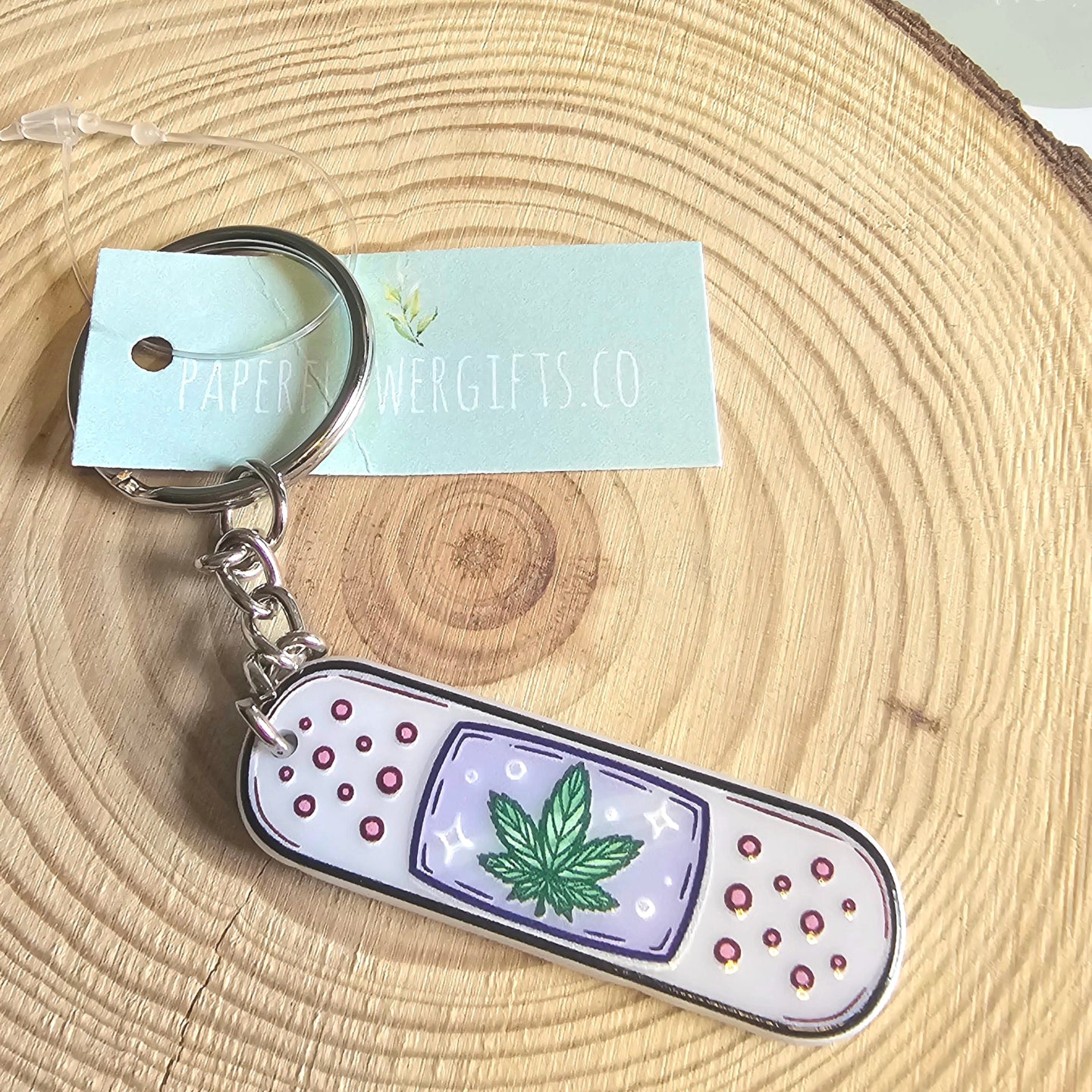 Sticky plaster with weed themed key ring