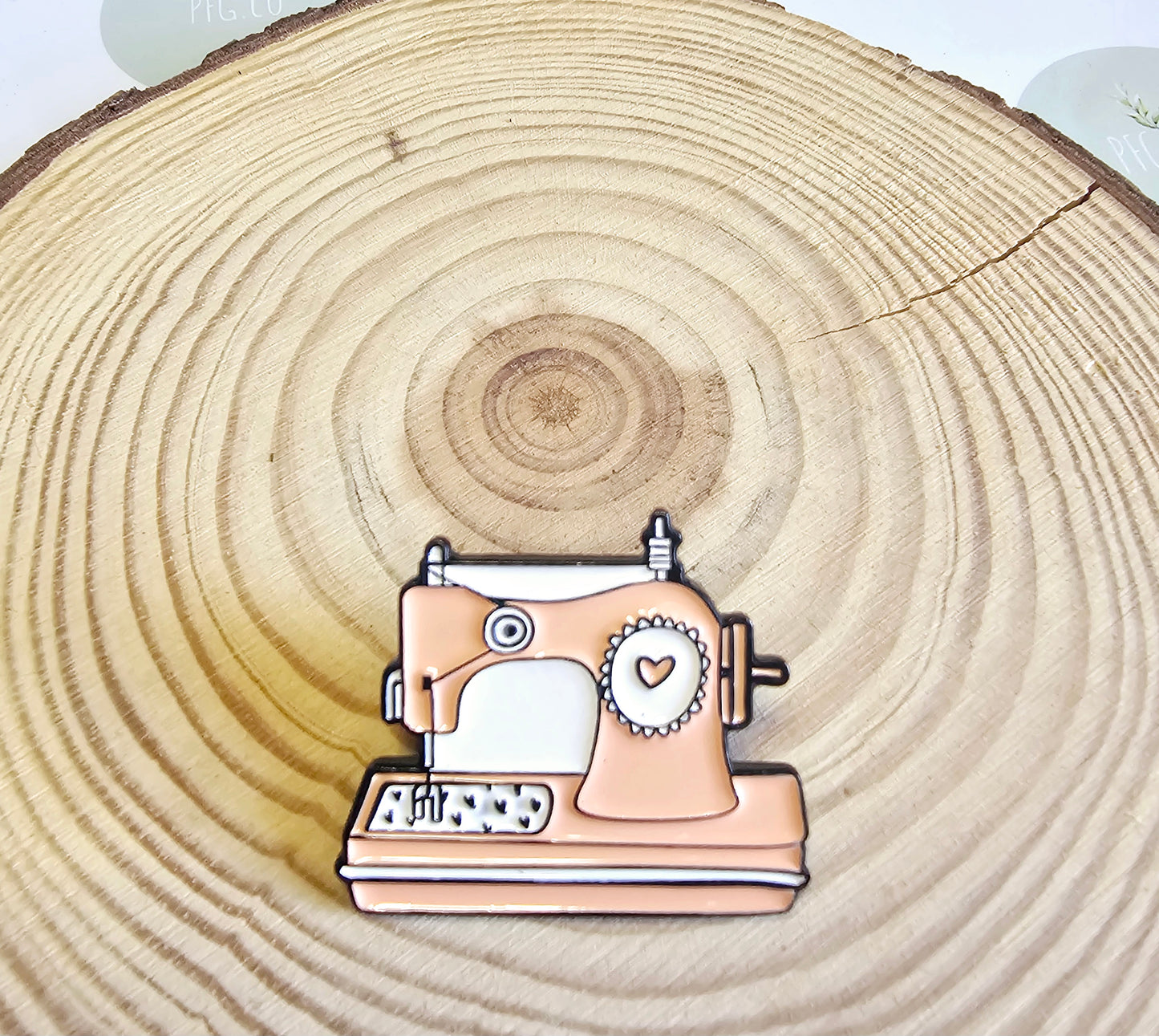 Sewing machine pin badge